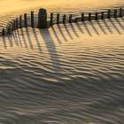 USA, New Jersey, Wildwood. Fence makes shadow patterns in sand. Art Print
